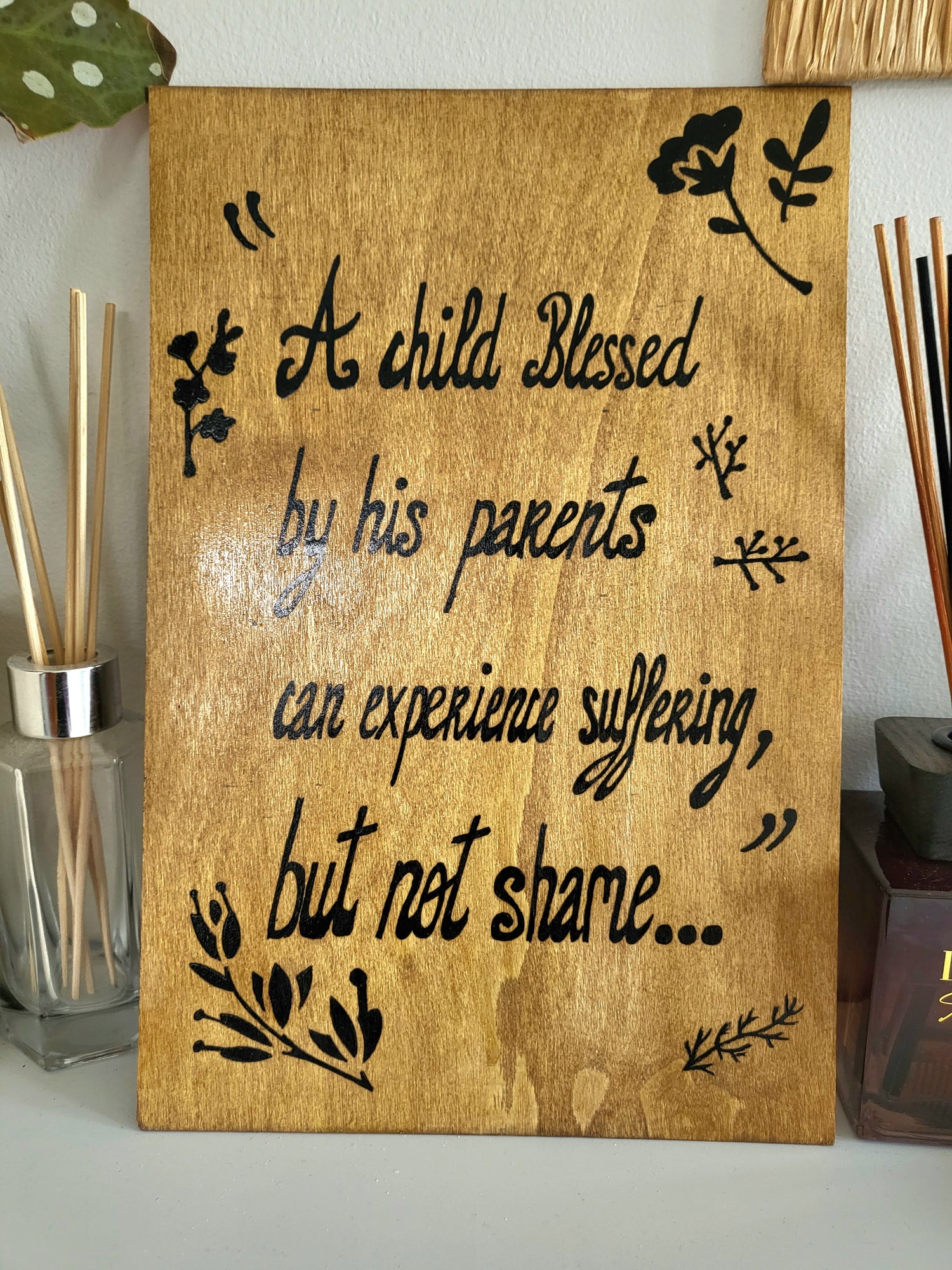 Light brown wood Art wall " A child blessed by his parents can experience suffering but not shame.."